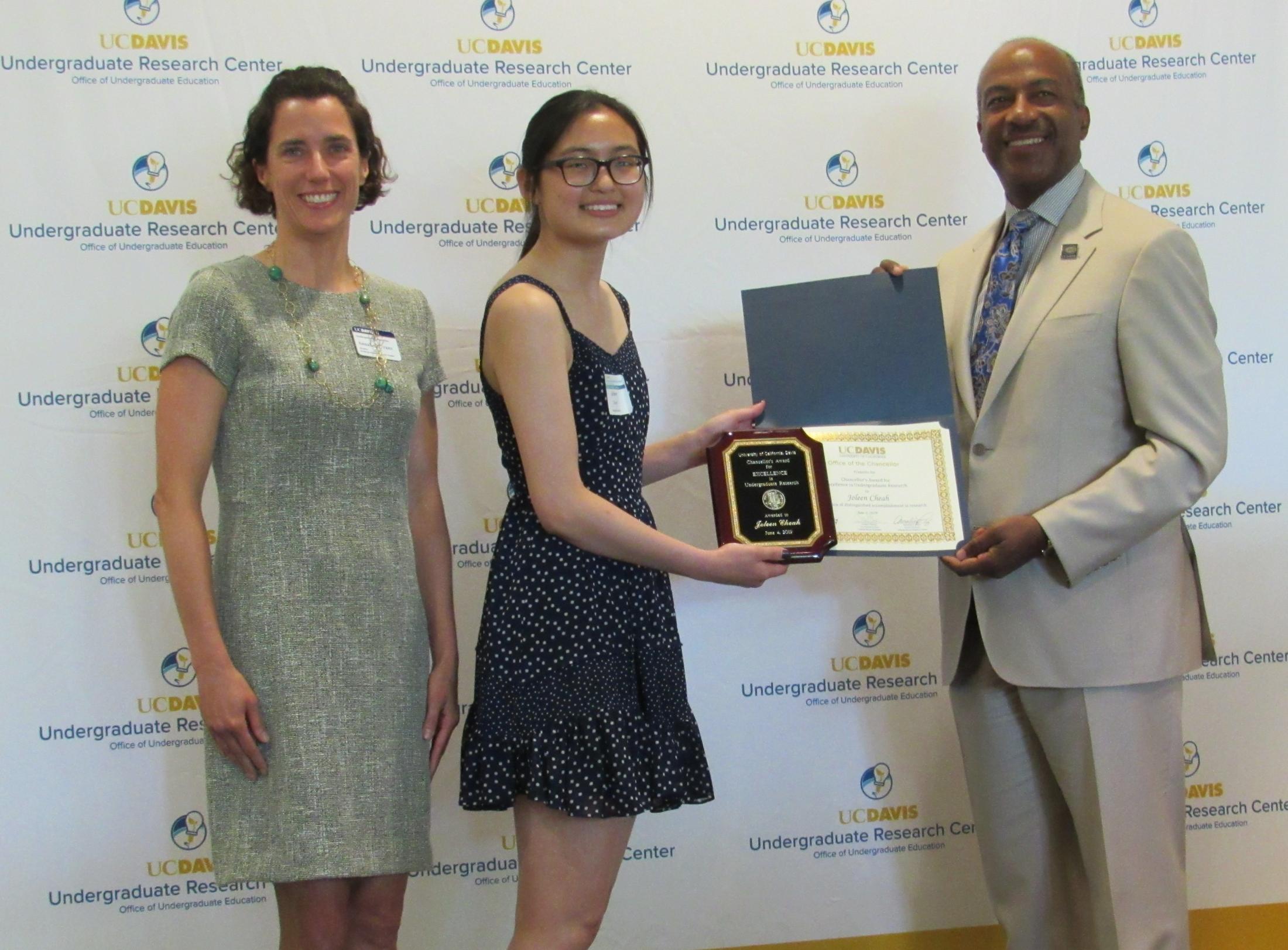 UC Davis University Honors Program student Joleen Cheah (center) with Chancellor Gary May (right) and URC Director Annaliese Franz (left) at the Chancellor's Award for Excellence in Undergraduate Research Awards Ceremony