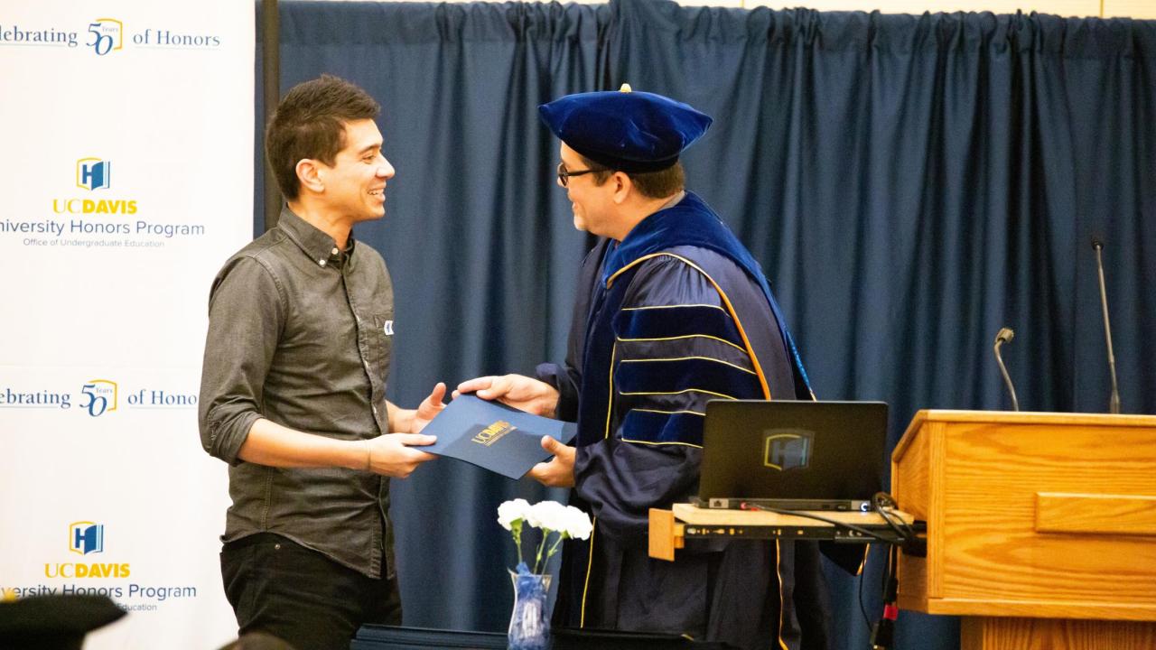 Professor Ryan Finnigan (left) receives the 2019 UC Davis University Honors Program Outstanding Mentorship Award from UHP Associate Director Eddy Ruiz (right)